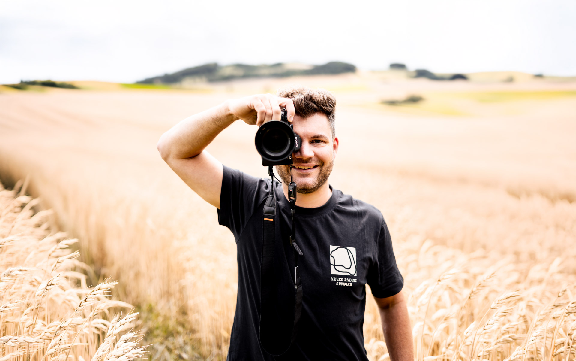 Stefan Möller mit Kamera auf einem Feld